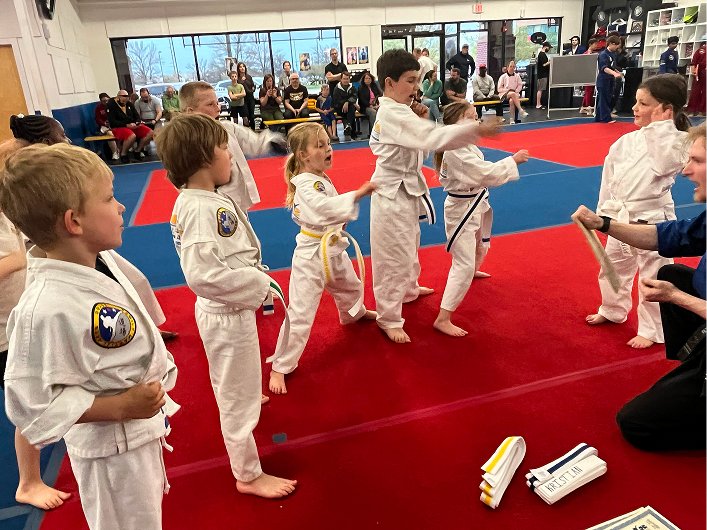 Johnston students lined up on the red mat during belt testing